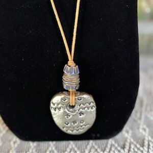 Blue, silver and gold toned hammered design pendant‎ necklace with leather cord.